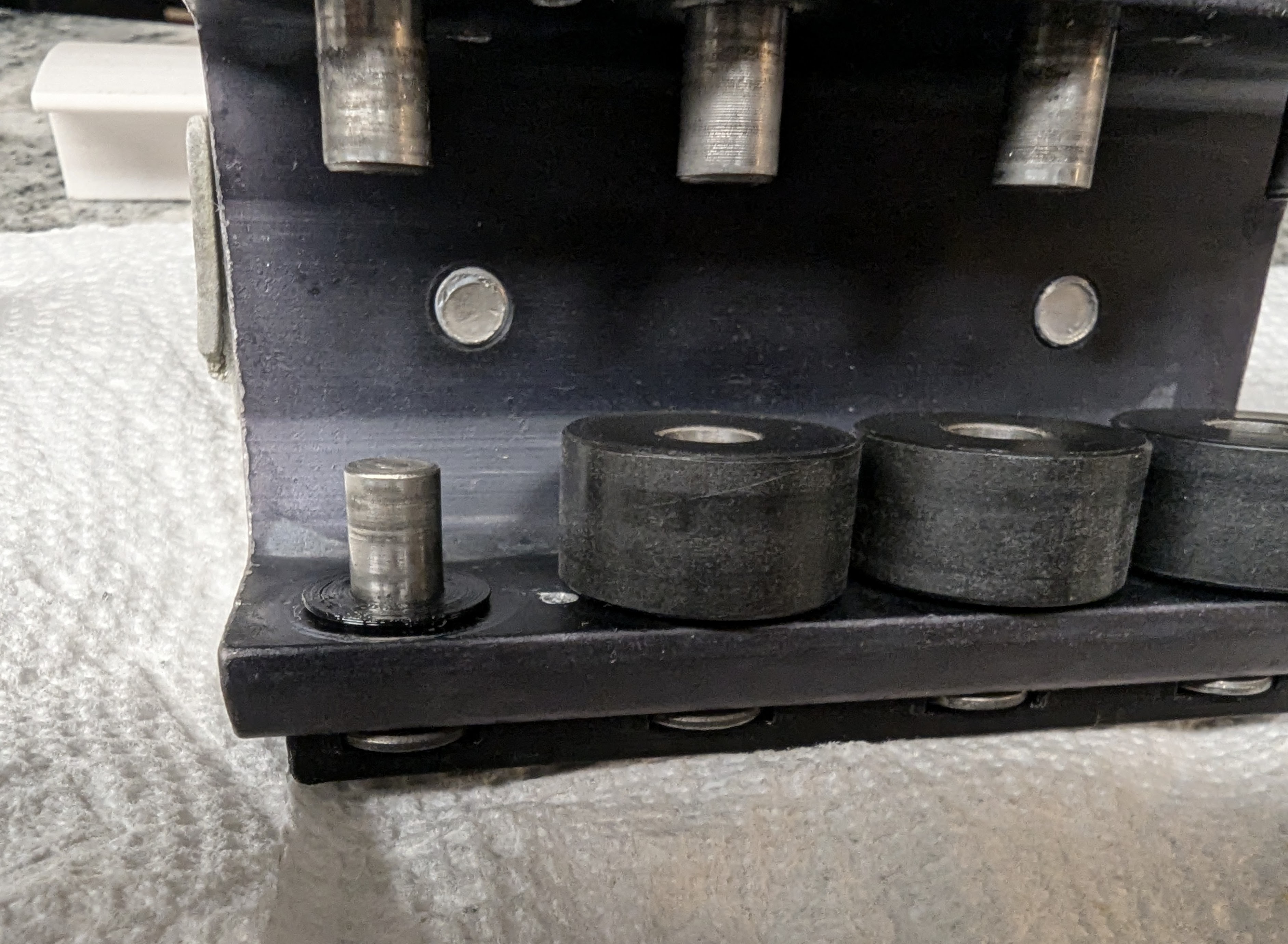 Image highlighting washer bearing installations: One axle is visible without a wheel, showing how the washer sits against the interior side of the car. The other wheels are present, showing how the washer creates a narrow gap between the wheels and interior of the car.