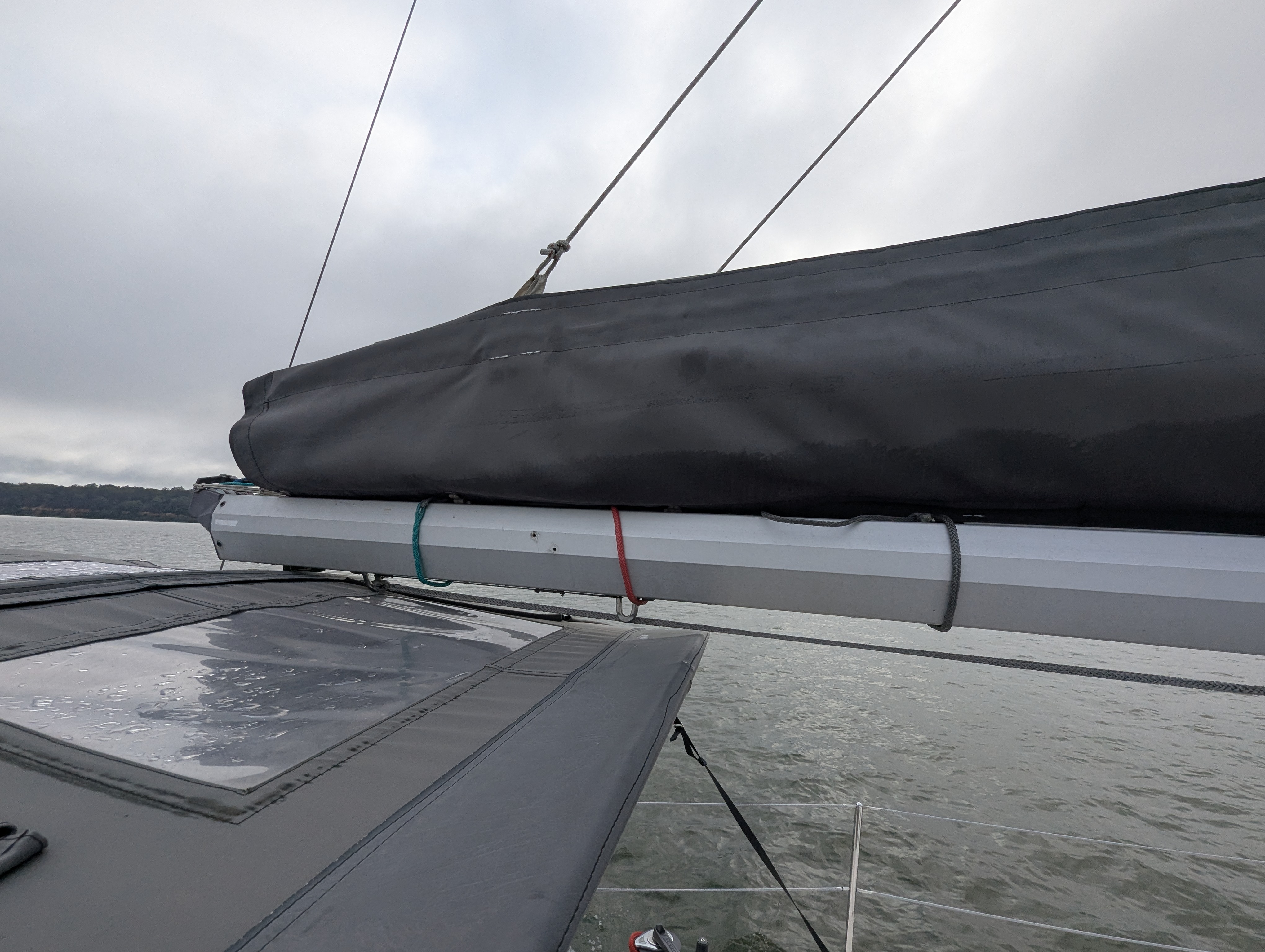 Side view of end of the boom with all three reef lines visible around the boom.