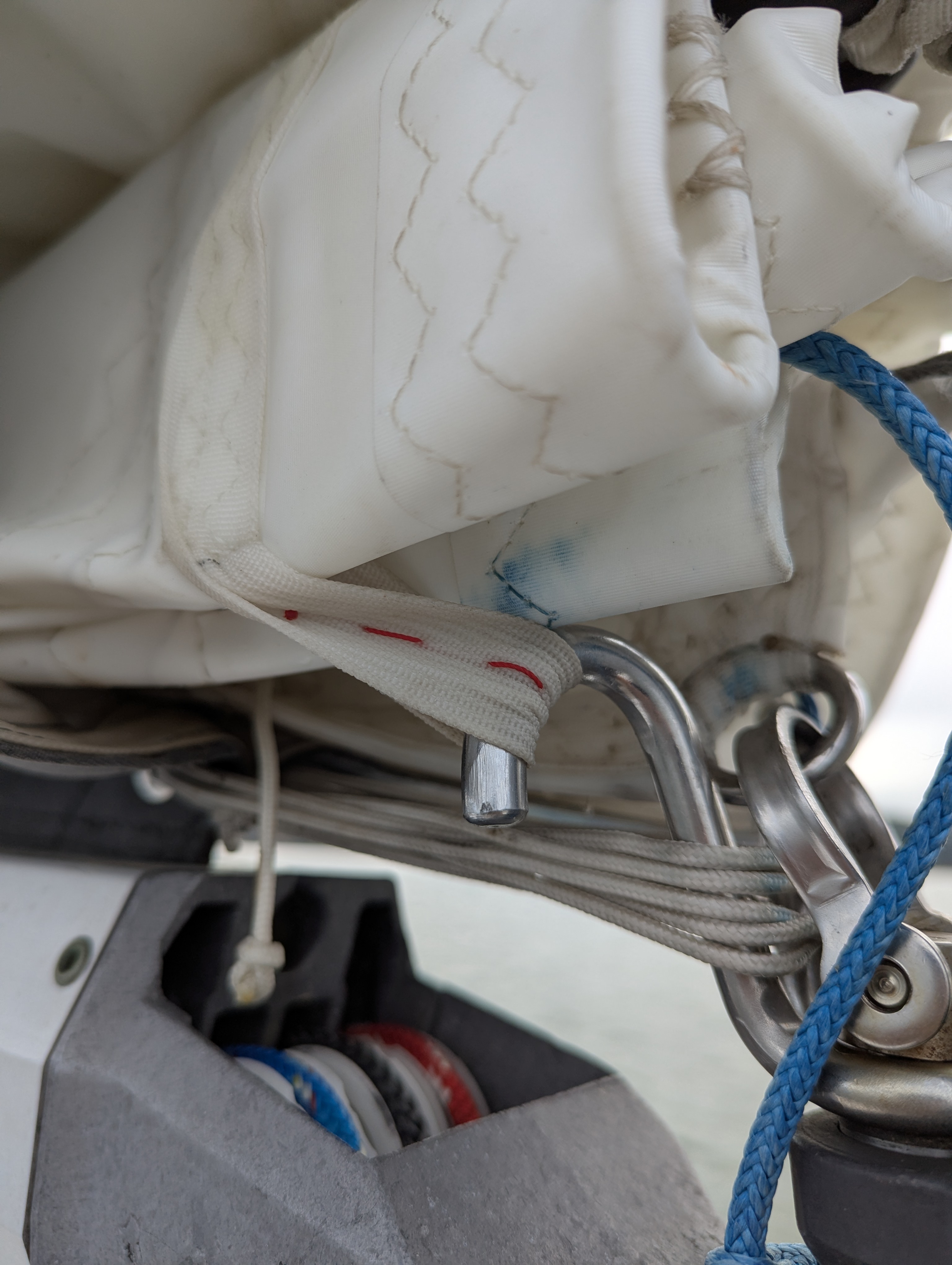 Reef strap hooked to reefing hook on gooseneck.